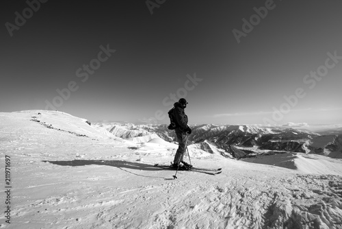 Skier on top of snowy ski slope