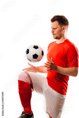 Fototapeta Naklejka Na Ścianę i Meble -  Young soccer player with ball on black background in studio.
