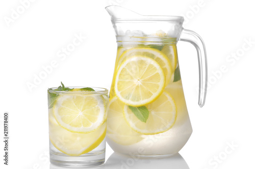 Homemade lemonade with mint and ice with a glass jug and a glass on a white background. isolated