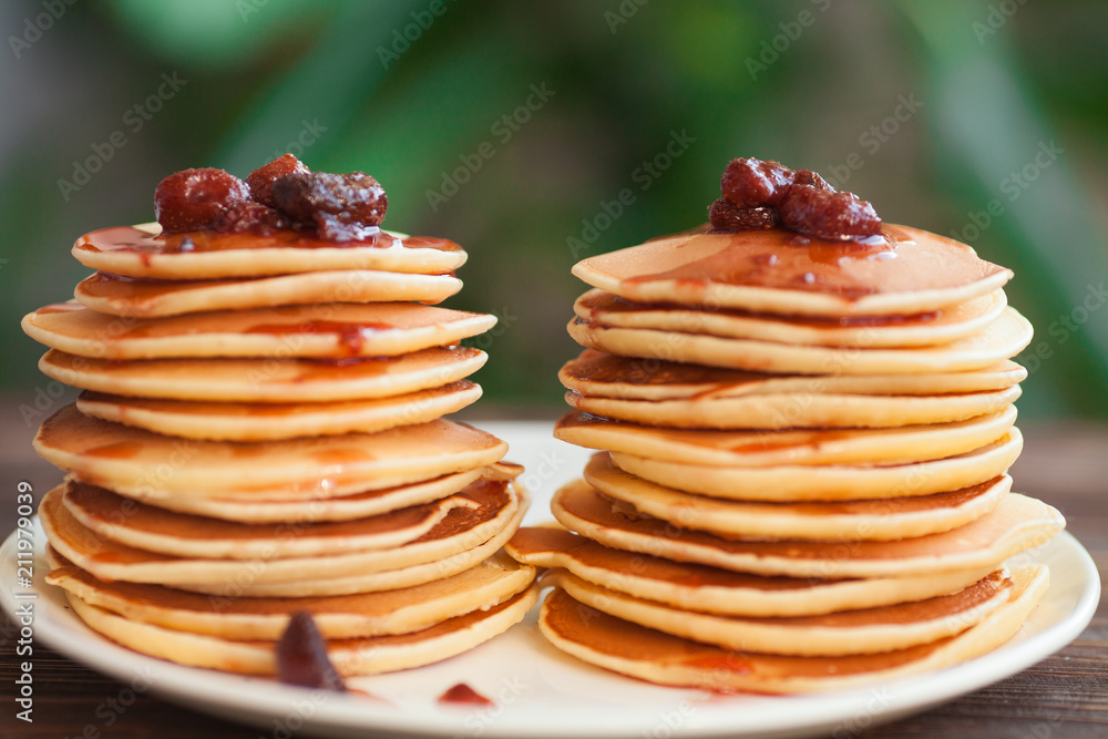 delicious pancakes on wooden table with strawberry jam delicious pancakes on wooden table with strawberry jam