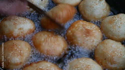 Asia. Asian street food. Fried donuts in oil