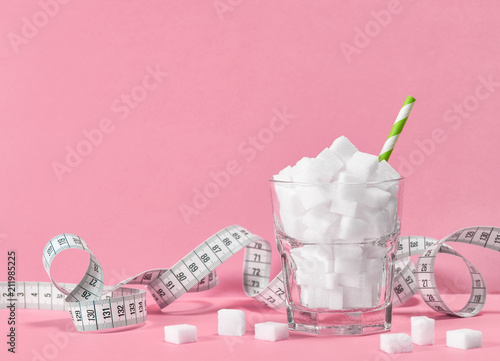 Fotografie, Obraz Glass sugar cubes measuring tape Weight control diet