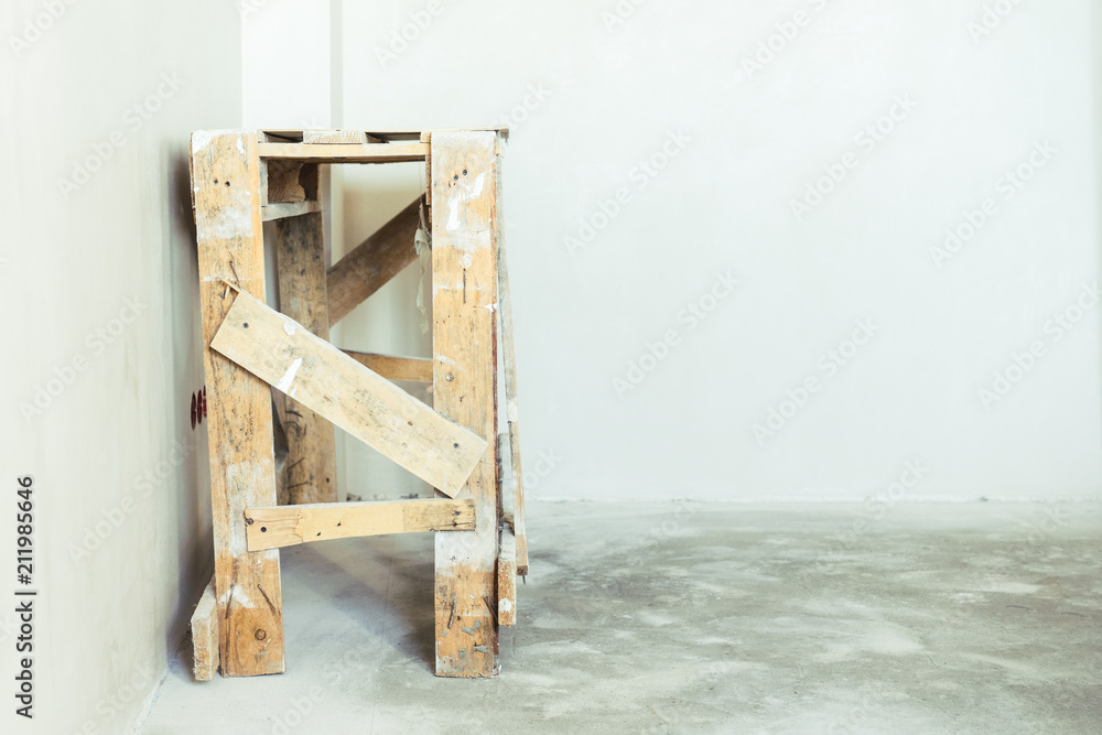 Construction grunge ladder white wall and gray floor. Apartment decoration concept. Construction grunge ladder white wall and gray floor. Apartment decoration concept.