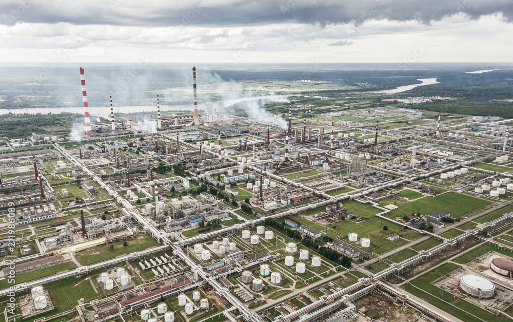 Aerial view of huge oil refinery with smokestacks and tanks