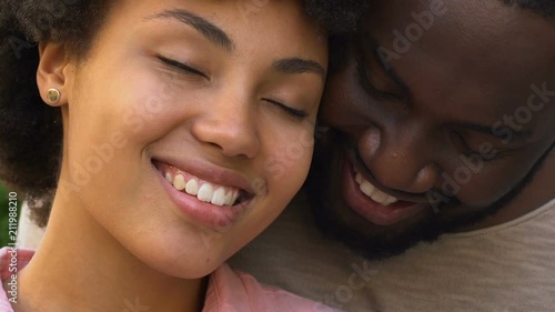 Happy afro american couple embracing and smiling, closeness, spiritual affinity