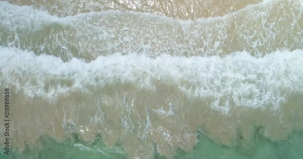 4k-Drone Video of Waves Crashing on Beach, Swimmer Runs Into Waves, Looking Straight Down and Flying Up, Spiraling 180 Degrees 4k-Drone Video of Waves Crashing on Beach, Swimmer Runs Into Waves, Looking Straight Down and Flying Up, Spiraling 180 Degrees