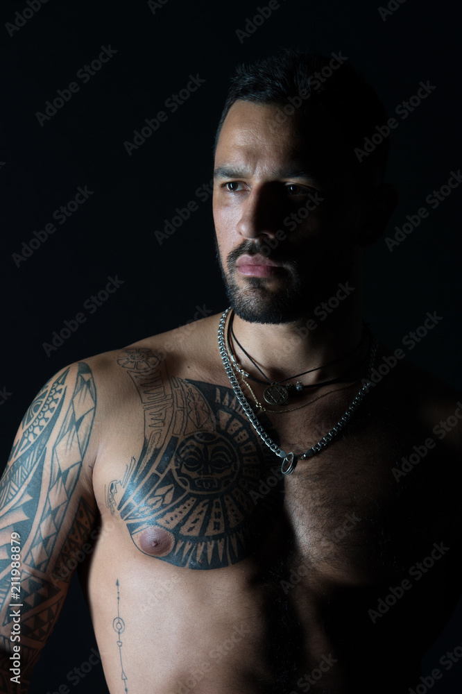 Man with sexy muscular torso. Bearded man with tattooed chest. Fit model  with tattoo design on skin. Sportsman or athlete with stylish beard and  hair. Bodycare or wellness and sport Stock Photo |