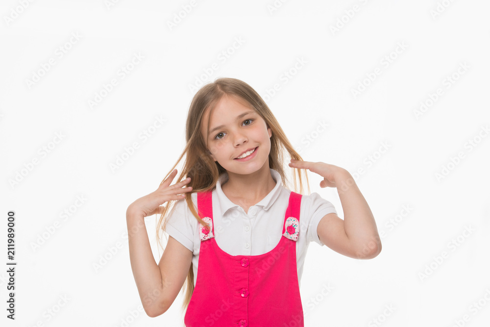Girl stroking her long blond hair. Lovely kid with charming smile, beauty and childhood concept. Child in pink outfit isolated on white background. Playful girl with big hazel eyes posing in studio Girl stroking her long blond hair. Lovely kid with charming smile, beauty and childhood concept. Child in pink outfit isolated on white background. Playful girl with big hazel eyes posing in studio