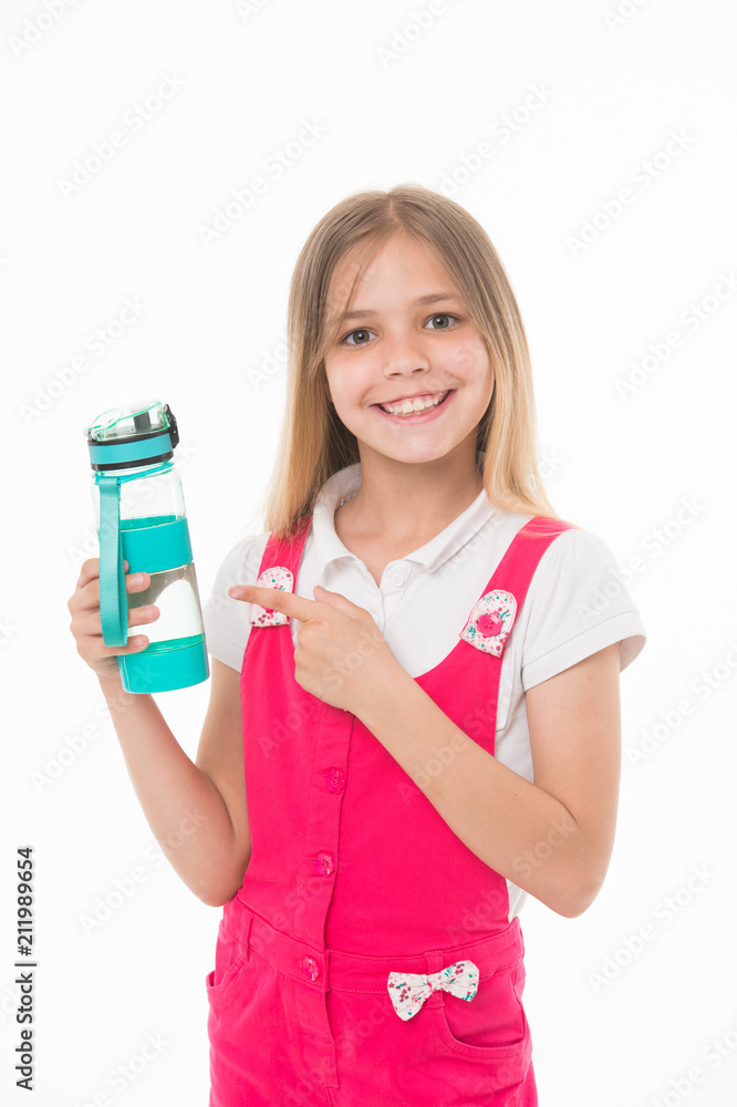 Girl holding a bottle of water. Kid with big smile wearing pink jumpsuit. Lovely child isolated on white background. Girl pointing at blue plastic bottle, healthy habits, nutrition concept Girl holding a bottle of water. Kid with big smile wearing pink jumpsuit. Lovely child isolated on white background. Girl pointing at blue plastic bottle, healthy habits, nutrition concept