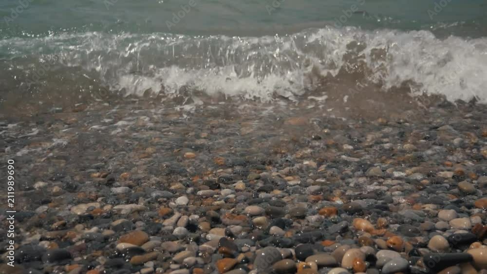 Silky waves on the sea pebbles. Shingle beach Silky waves on the sea pebbles. Shingle beach