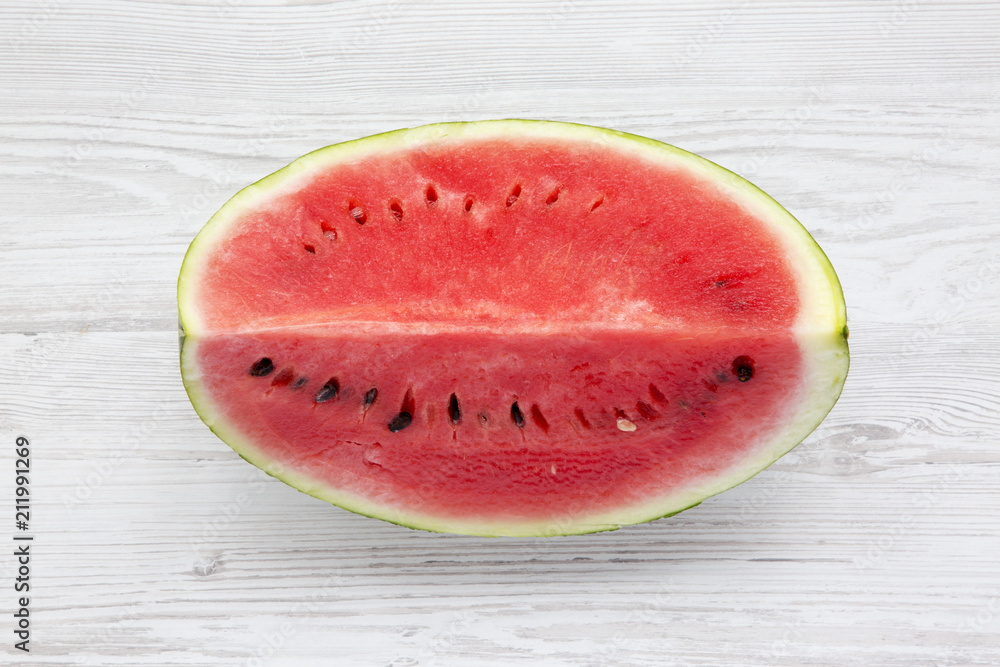 Fresh cut watermelon on a white wooden background, view from above. Fresh cut watermelon on a white wooden background, view from above.