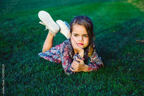 Girl day dreaming liying on the grass photo