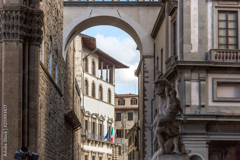 Scenery with arch and sculpture in the streets of Florence