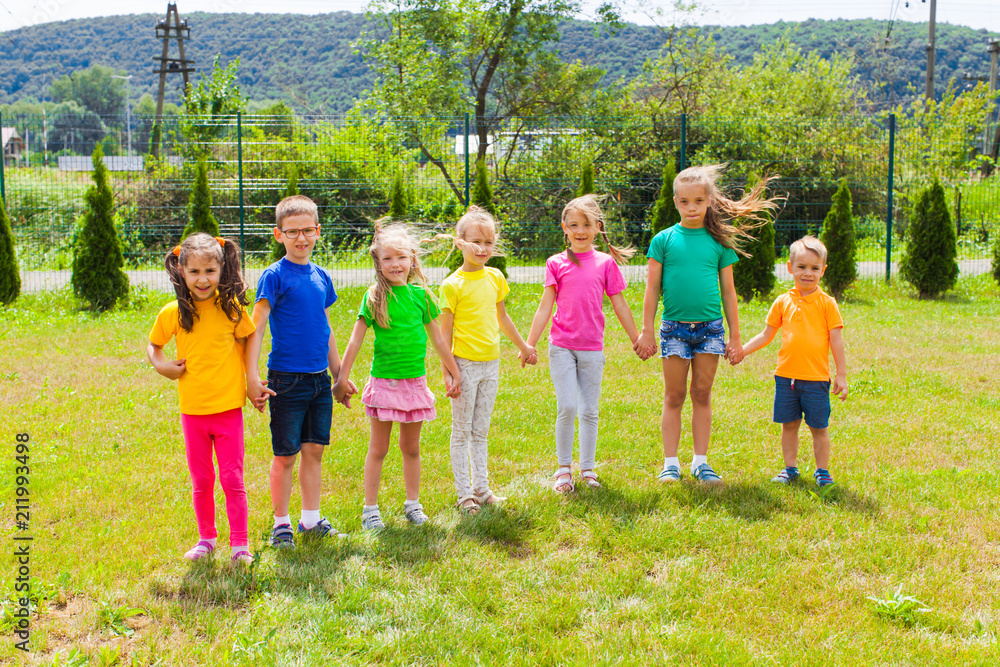 Obraz premium Happy cheerful kids in colorful t-shirts