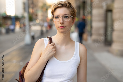 Woman in city walking street serious face © blvdone