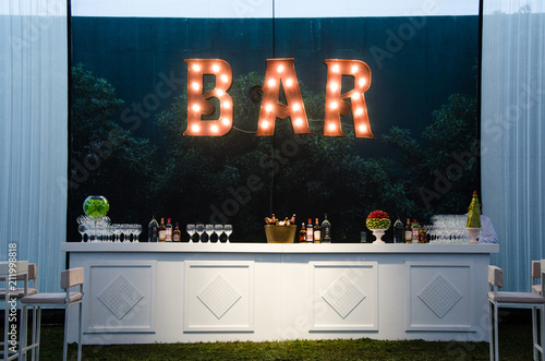 The bar is an open sign, the wooden bar painted white for a wedding photo