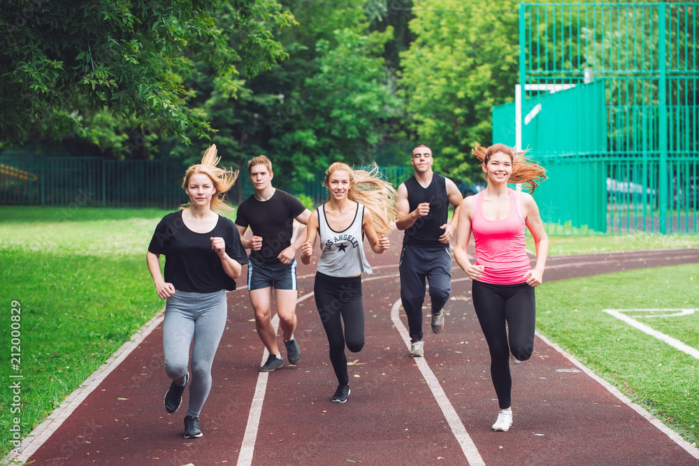 Professional runners running on a race track. Professional runners running on a race track.