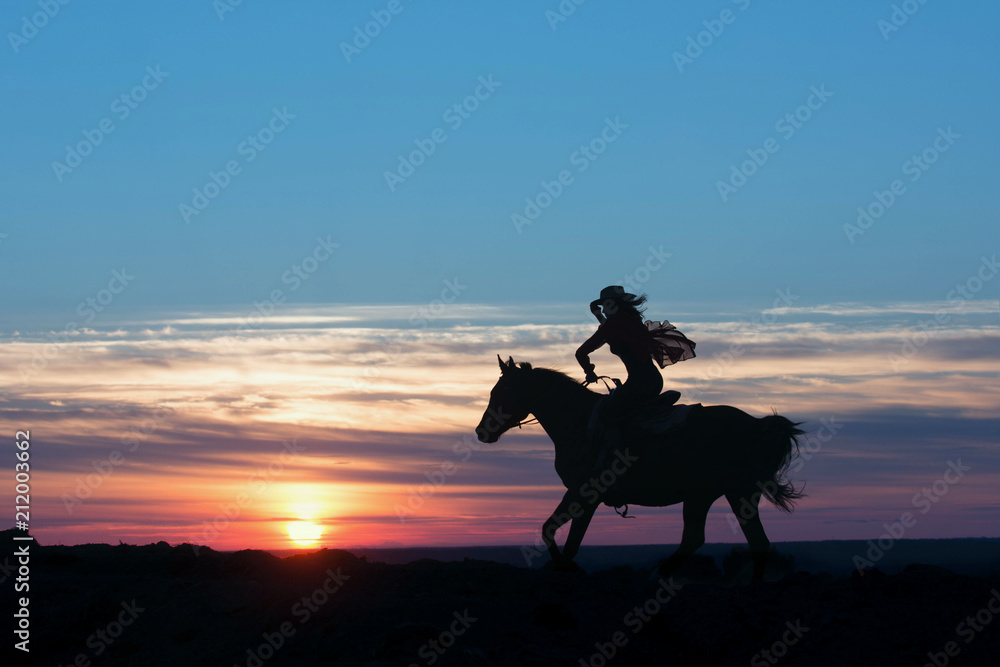 Cowboy postman running in rays of the setting sun and hold the hat on head. Western concept.