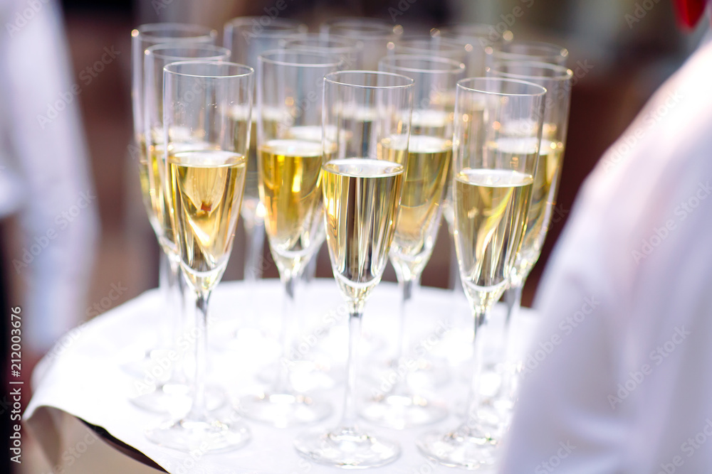 Glasses with champagne on a tray. Meeting the guests. Glasses with champagne on a tray. Meeting the guests.