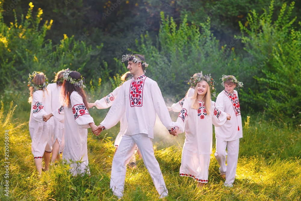Obraz premium Midsummer. A group of young people of Slavic appearance at the celebration of Midsummer.