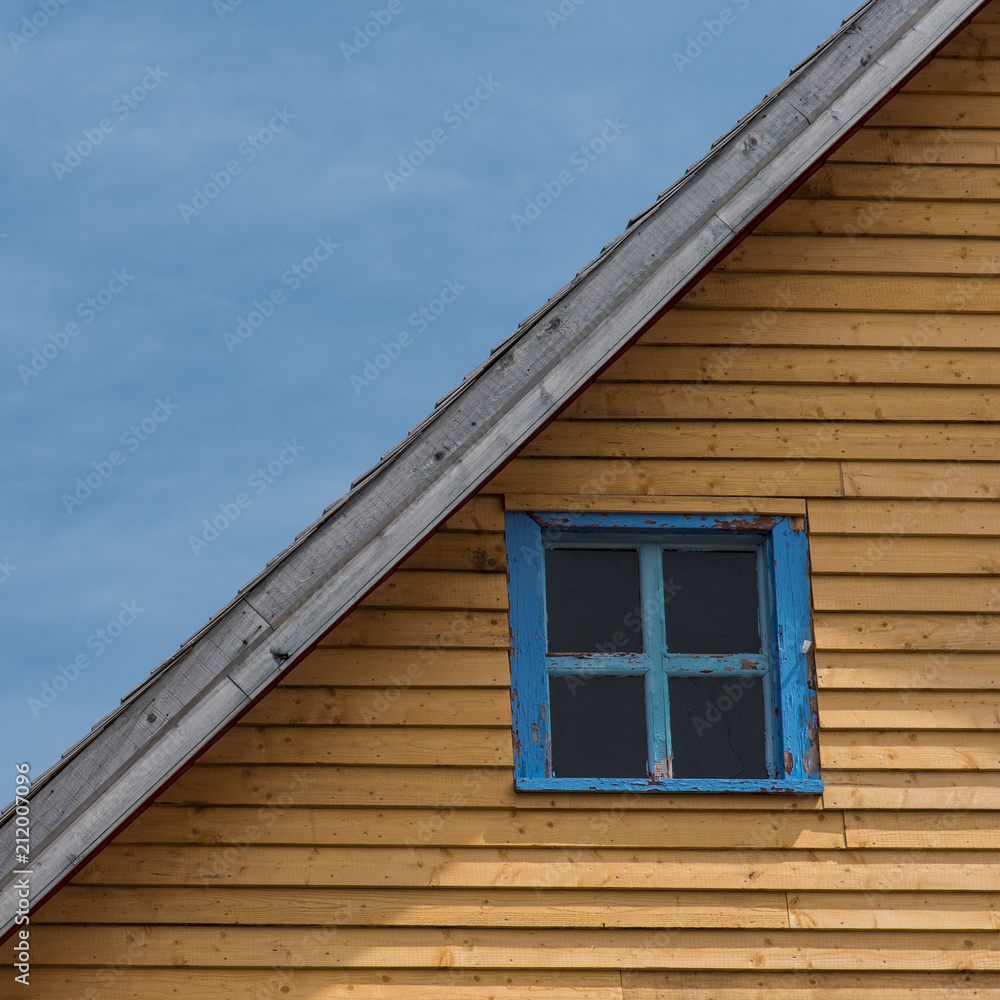 Colorful house and window frame against blue sky Colorful house and window frame against blue sky