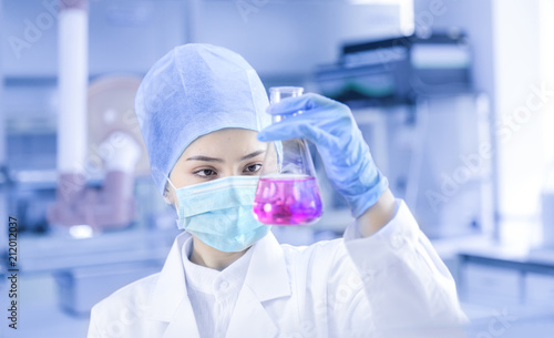 Female scientist looking at the sample in the laboratory