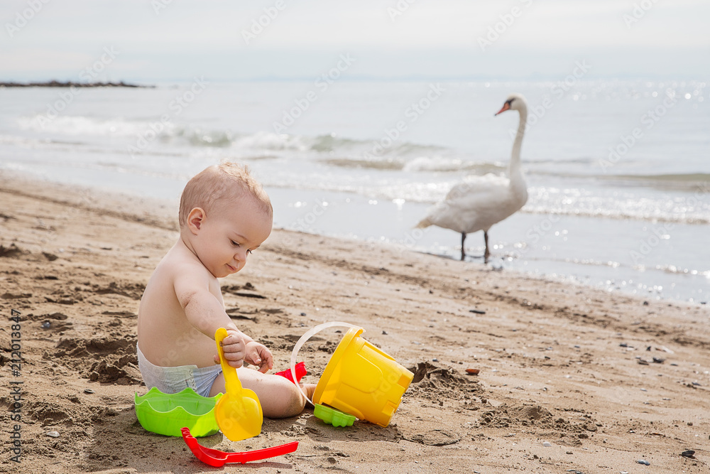 Cute baby boy playing with beach toys Cute baby boy playing with beach toys