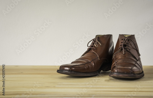 Brown leather boots on wooden floor