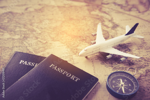 Passport, plane, compass placed on map -concept travel