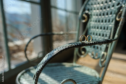 Wedding rings on the stool at the window