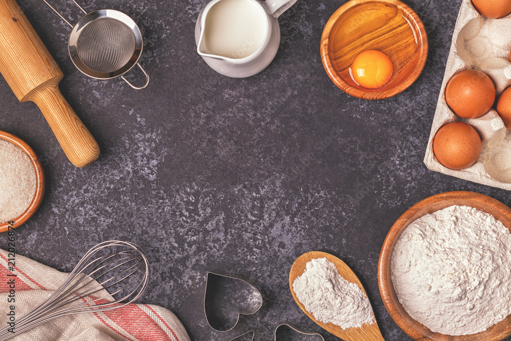 Ingredients for baking - flour, wooden spoon, rolling pin, eggs Ingredients for baking - flour, wooden spoon, rolling pin, eggs