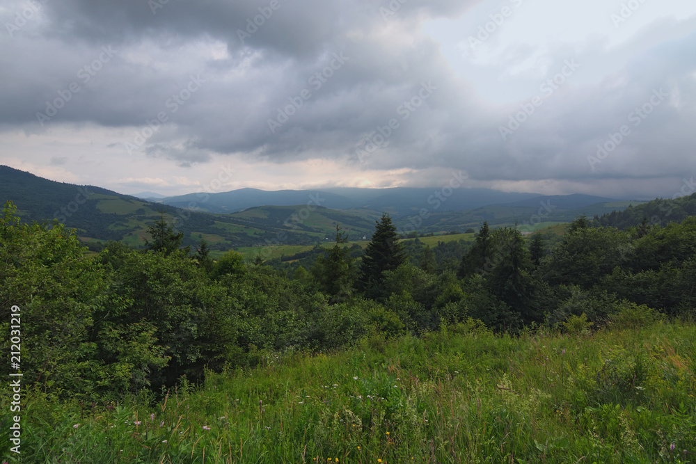Nature in the mountains. Stunning mountain landscape of Ukrainan Carpathian. View from the top of Verecke Pass. Cloudy summer day. Zakarpatska oblast, Ukraine