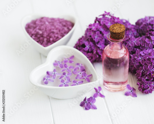 Essential oil and sea salt with lilac flowers