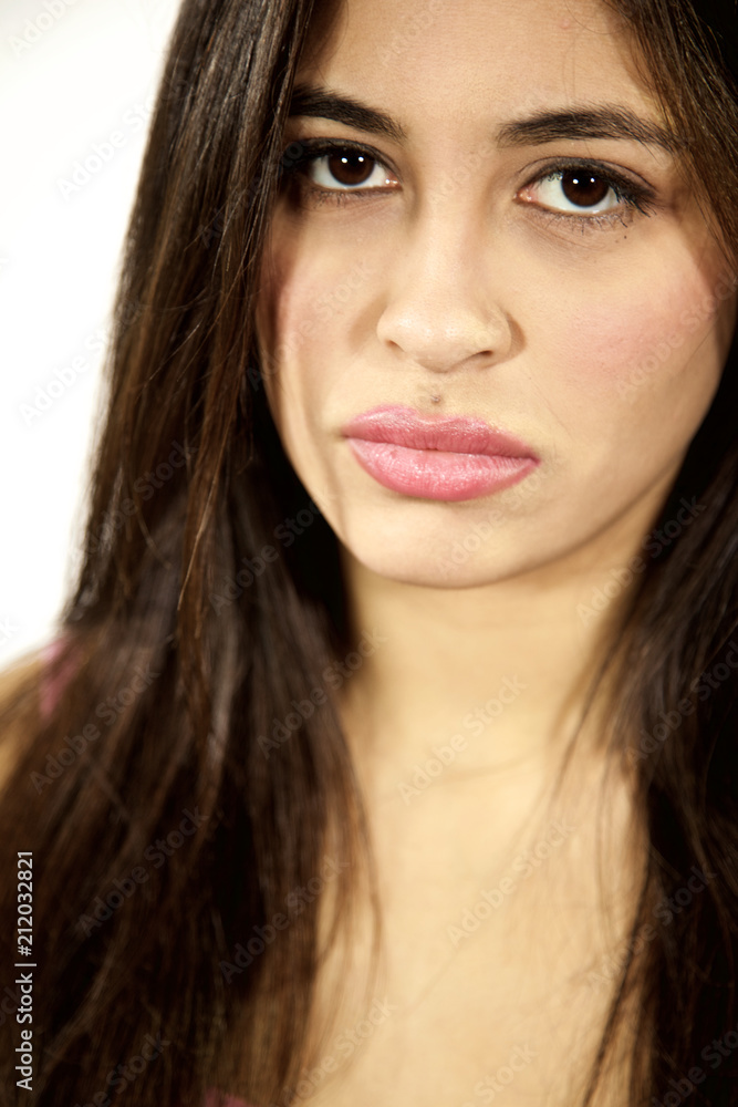Serious sad young hispanic woman isolated looking camera. Serious sad young hispanic woman isolated looking camera.