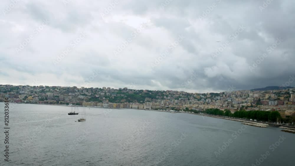 Group common seagulls flying on the mediterranean see with Naples in the background, Italy. A gull fly over the ocean. Flock of seagulls on the seashore. Bird free flight-Dan Group common seagulls flying on the mediterranean see with Naples in the background, Italy. A gull fly over the ocean. Flock of seagulls on the seashore. Bird free flight-Dan