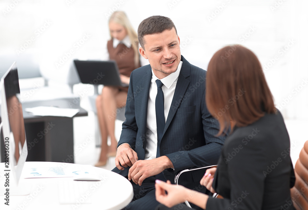 Manager talking with a colleague at the workplace Manager talking with a colleague at the workplace
