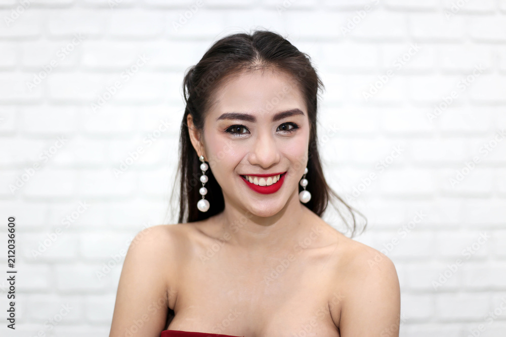 Happy smiling beautiful young sexy woman in red party dress Happy smiling beautiful young sexy woman in red party dress