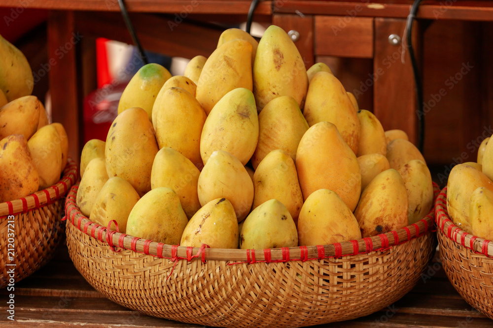 Yellow mango in a basket on the market
