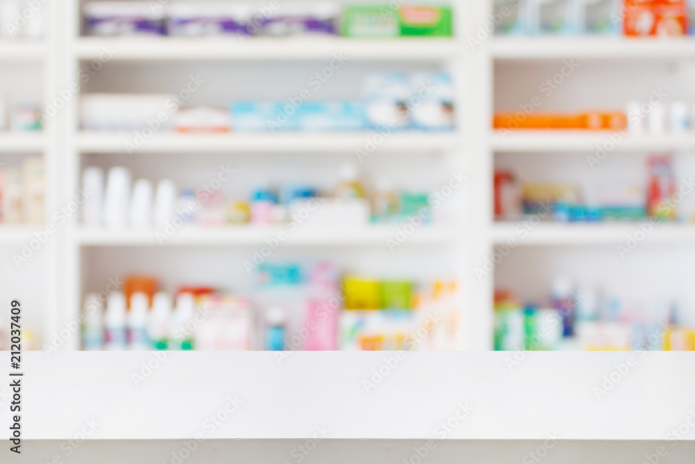 Pharmacy drugstore counter table with blur abstract backbround with medicine and healthcare product on shelves