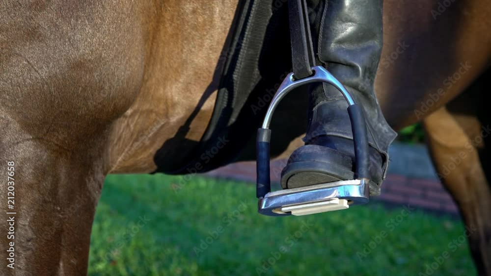 4K, Closeup of the iron stirrups on the saddle of a police riding