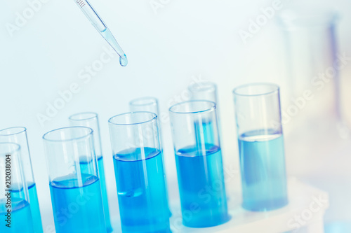 Science Glass test tube blue color in research lab for sci background wallpaper.
