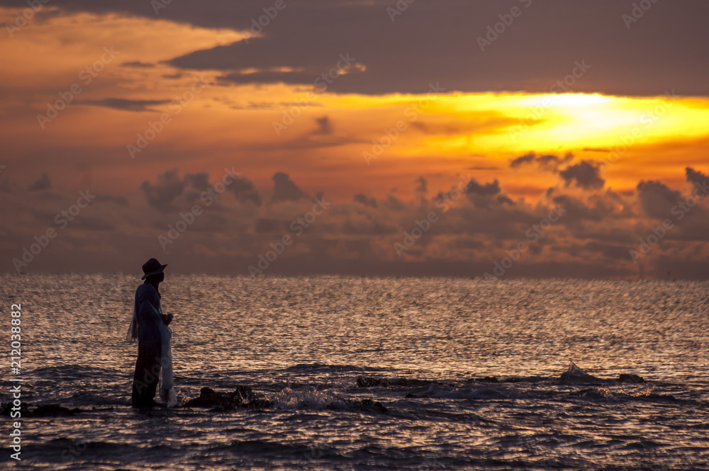 Local fisherman and sunset beach