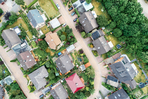 Schilderij op canvas Vertical aerial view of a suburban settlement in Germany with detached houses, close neighbourhood and gardens in front of the houses