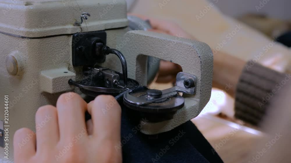 Professional male skinner, furrier using special sewing machine for ...