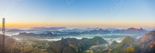 Panorama of karst mountains with mist at sunrise, Vang Vieng, Vientiane Province, Laos, Asia photo