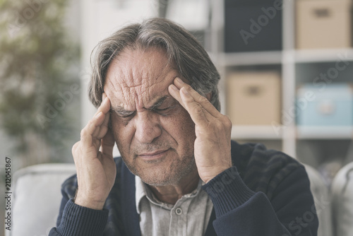 Old man suffering from headache