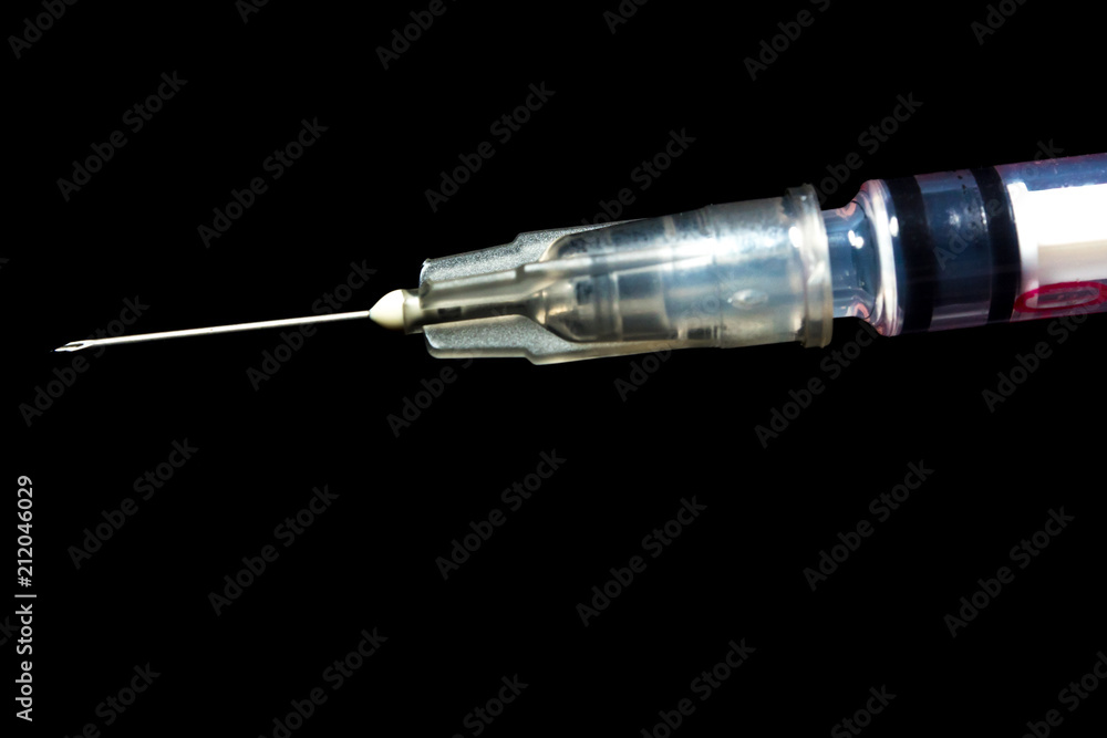 Syringe, injection needle on black background Syringe, injection needle on black background