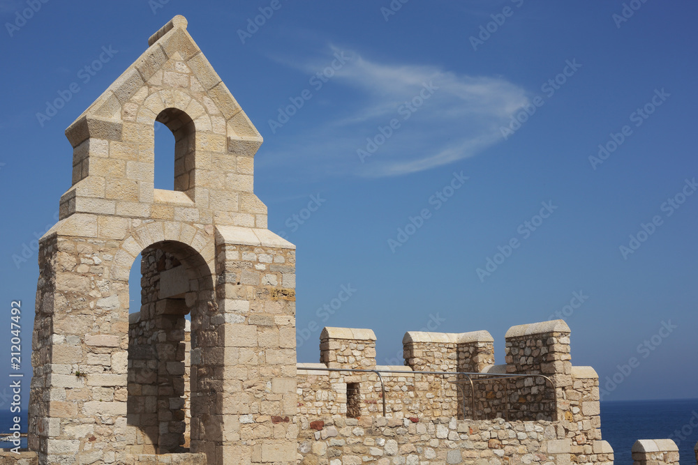 walls of the old stone castle on the blue sky background