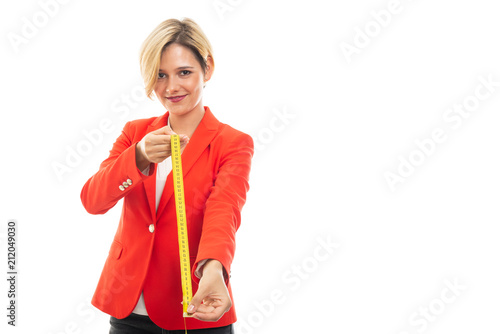 Young pretty business woman measuring with yellow tape.