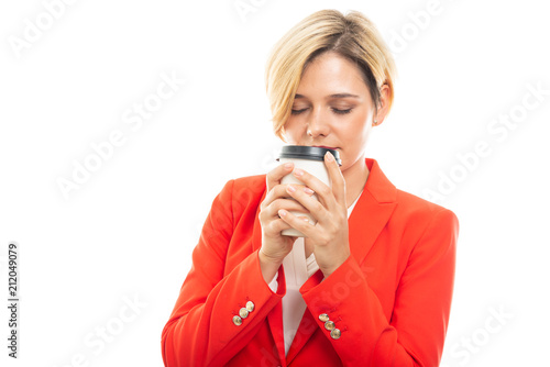 Young pretty business woman smelling takeaway coffee cup.